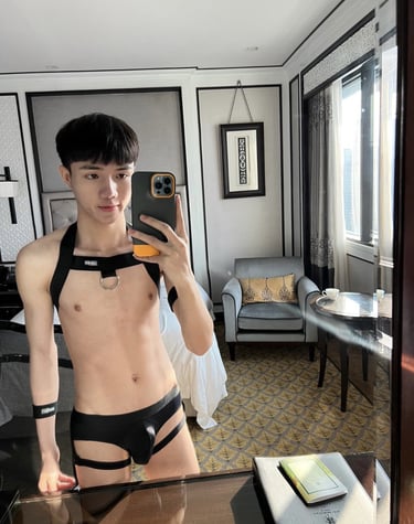 slim guy wearing black men's lingerie