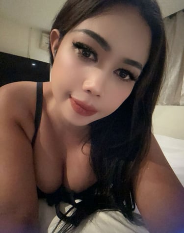 Lady therapist lying on bed taking a close up selfie