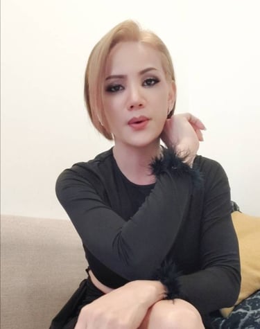 ladyboy with short blonde hair and black top ready for outcall massage
