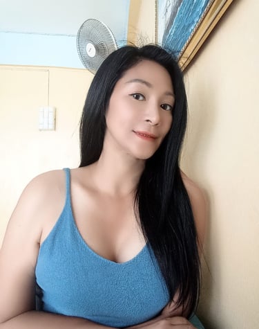 half body photo of a lady with long black hair and a blue crop top