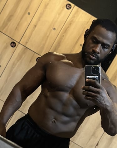 Black guy with muscular physique wearing black shorts taking photo r