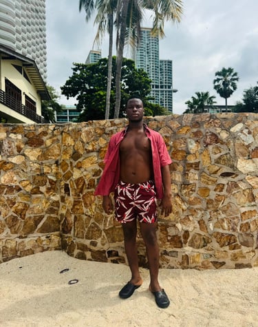 Male therapist wearing red and white shorts and red short sleeve shirt with buttons open