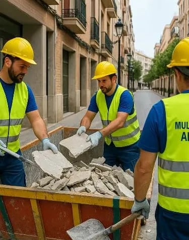 Equipo de trabajo llenando un contenedor de escombros, equipodos con el traje de seguridad