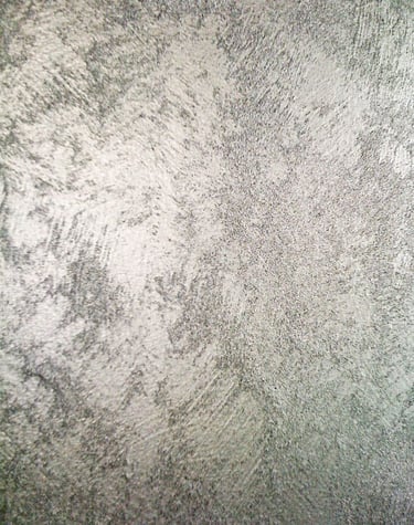 A cool silver paint sample showing off its shimmering grainy texture.