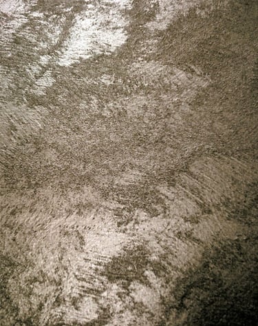 A warm silver paint sample showing its lustre and beautiful grainy texture.
