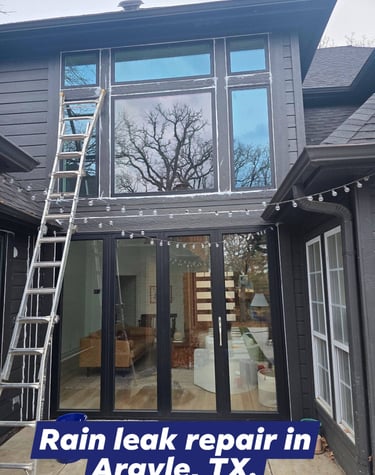 Giant windows getting sealed on a two story house in Argyle, TX
