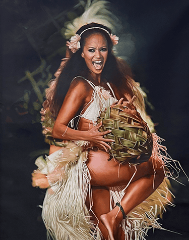 Polynesian dancer in traditional grass skirt performing a cultural hula dance with a woven basket.