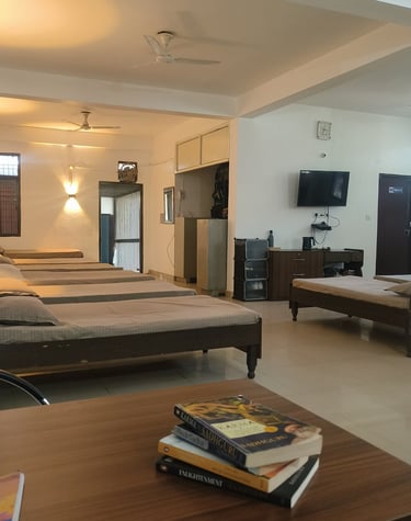 Spacious open-concept residential ward at Mehar Rehabilitation with wooden beds, clean linens.