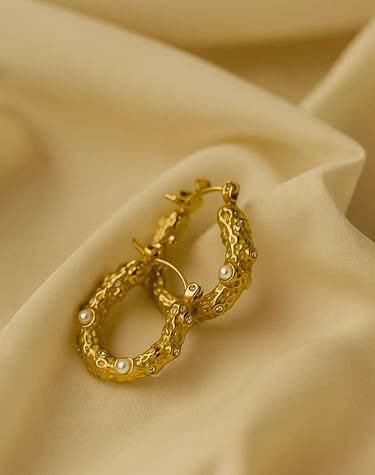 a pair of gold earrings with pearls and pearls