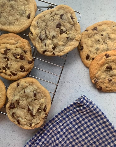 freshly baked sugar cookies displayed before a farmers market selling assorted baked goods