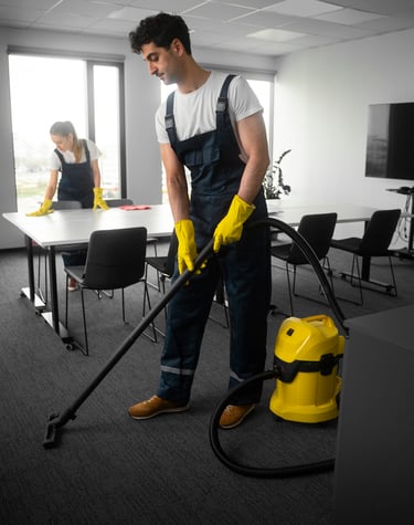 a man in overall cleaning a room
