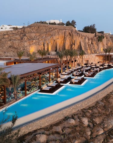 a large pool with a mountain in the background