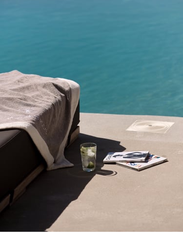 a bed with a book and a glass of water