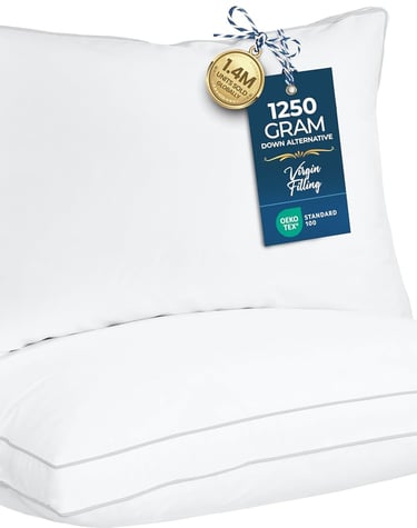 Two stacked white down alternative bed pillows with grey piping and Oeko-Tex certification labels.