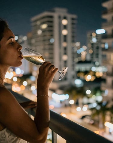 Close-up of a polished steering wheel inside a luxury car, reflecting the city skyline.