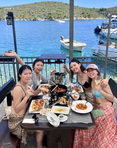 Girls enjoying seaside lunch in Sesula restaurant on Solta island during private boat trip from Split