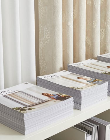 Elegant layered curtains in warm earth tones framing a large window with garden views.