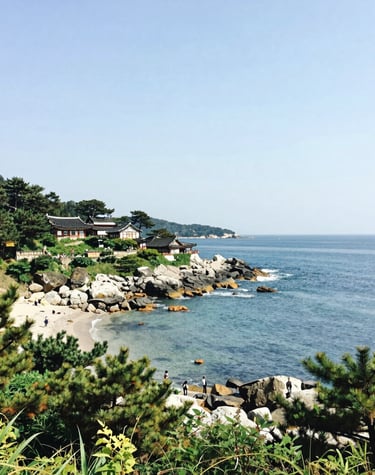 A colorful street market bustling with smiling vendors and fresh produce under bright blue skies.