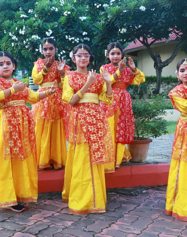 A group of girls in traditional attire showcasing a synchronized folk dance during the annual functi