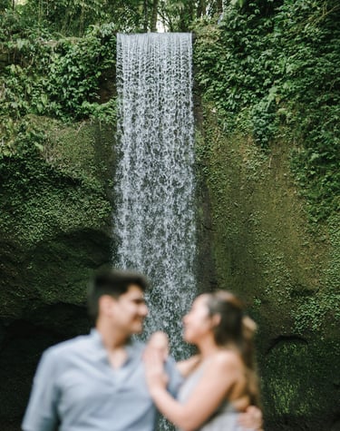 Intimate prewedding couple portrait with Tibumana Waterfall backdrop in Bangli Bali
