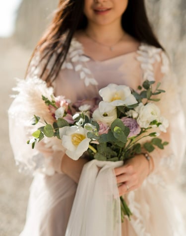 Elegant bride holding bouquet during prewedding session at Melasti Beach Bali