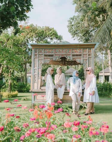 Group of friends walking near flower garden during photoshoot at Candi Beach Resort Karangasem Bali
