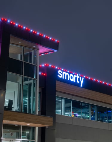 Red and white lights shining at night that are installed on a business 