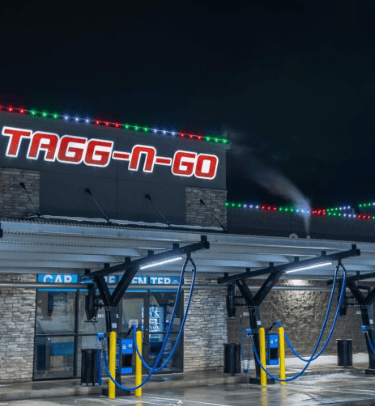 Christmas colored lights shining at night that are installed on a car wash