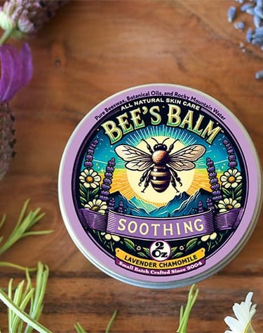 Tin of Soothing Bee's Balm surrounded by Lavender Sprays and buds & Chamomile flowers and 
