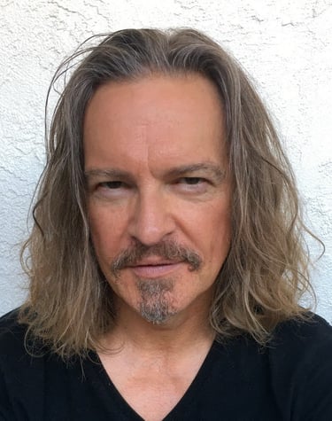 Headshot of Todd Long with long hair, moustache, and goatee
