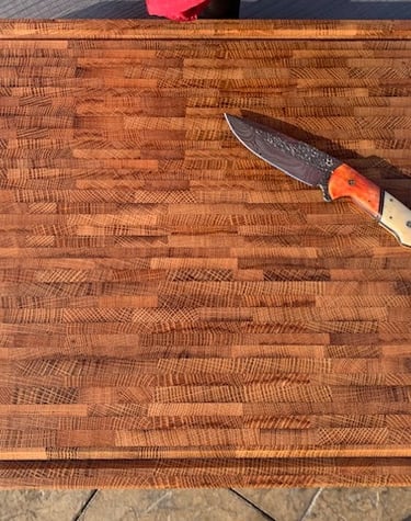 Large end grain cutting board made from recycled bourbon barrel.