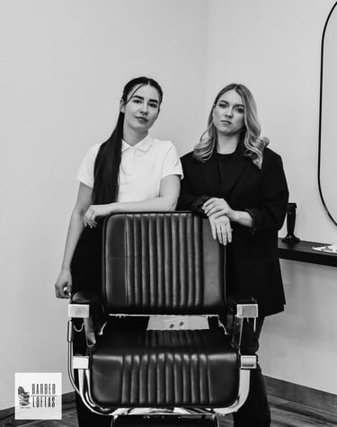 two women standing in front of a hair salon