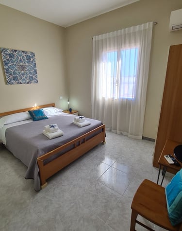 a bedroom with a bed and a chair