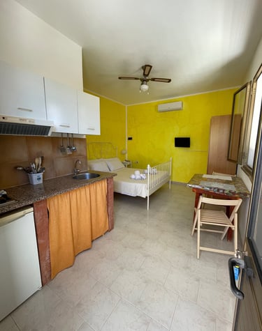 a kitchen with a bed and a kitchen