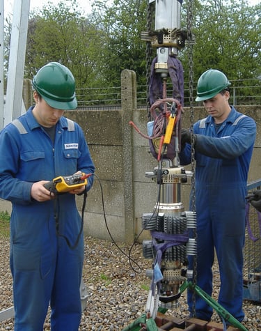 a group of men in blue workwears and safety gear