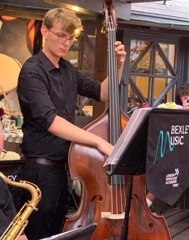 An image of Jamie Walker performing jazz on his double bass