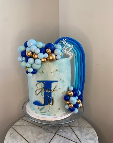 a cake with a blue and gold cake topper