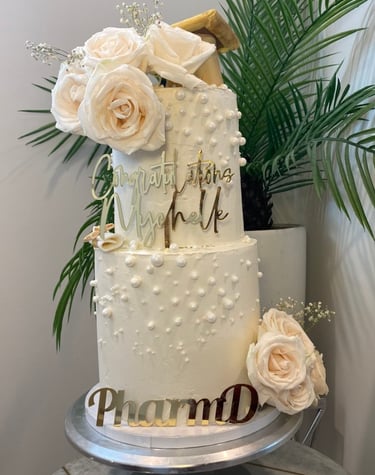 a cake with a white cake topperf and flowers