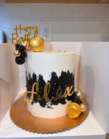 a cake with a gold birthday cake topper
