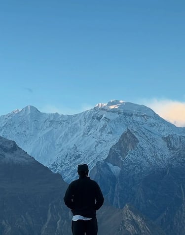 Akram Posh standing in front of Rakaposhi Mountain in Hunza Valley, Pakistan.