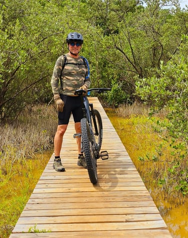 a man riding a bike on a wooden bridge