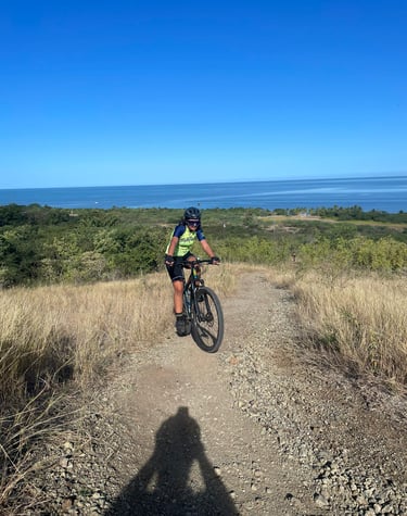 a person riding a bike on a dirt road