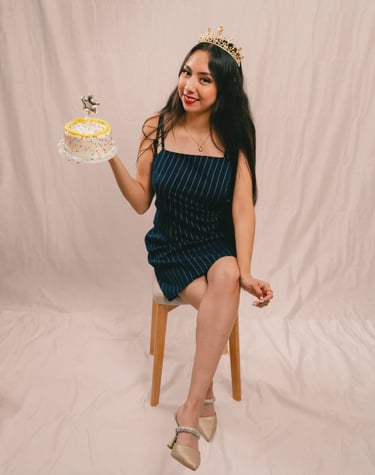 a woman in a dress and tiablet with a cake