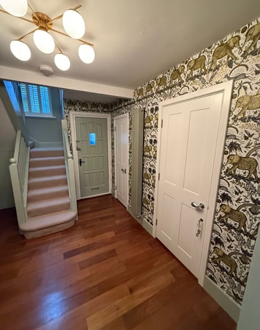 Modern hallway featuring safari animal wallpaper, hardwood floors in Sussex.