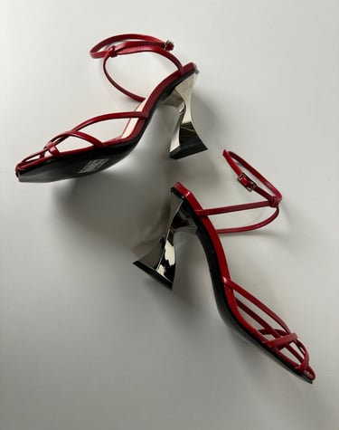 Judy Mazzotti pair of red shoes with a pair of heels