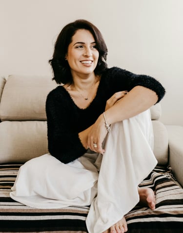 a woman sitting on a couch with her feet on the couch