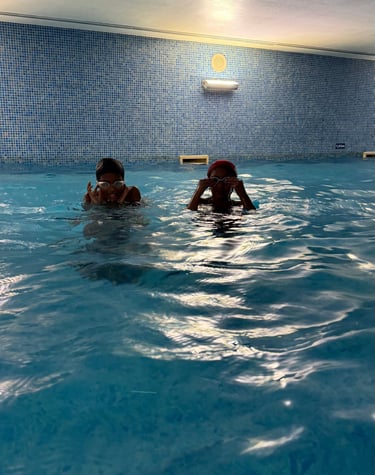 two kids in a pool w goggles