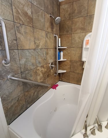 Handicap accessible bathroom with walk-in jetted tub, brown tile walls, and safety grab bars.