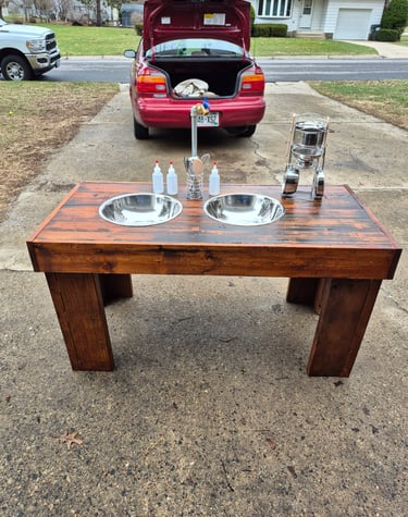 Handmade outdoor wooden mud kitchen for kids with double stainless steel sinks and play utensils.