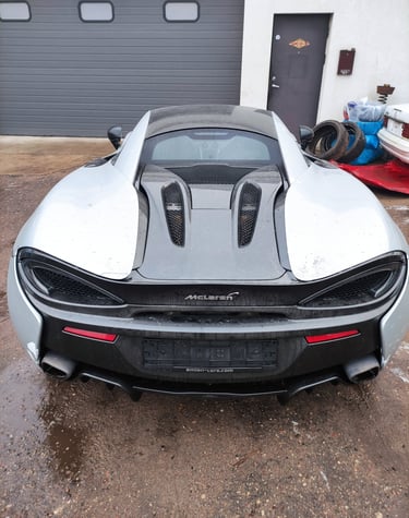 an Enlab McLaren car with a large hood and a hood on it